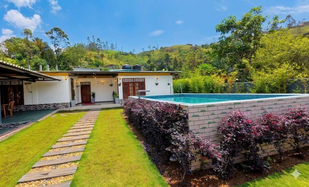a house with a swimming pool in a yard at Akshayaam Villa in Kotagala