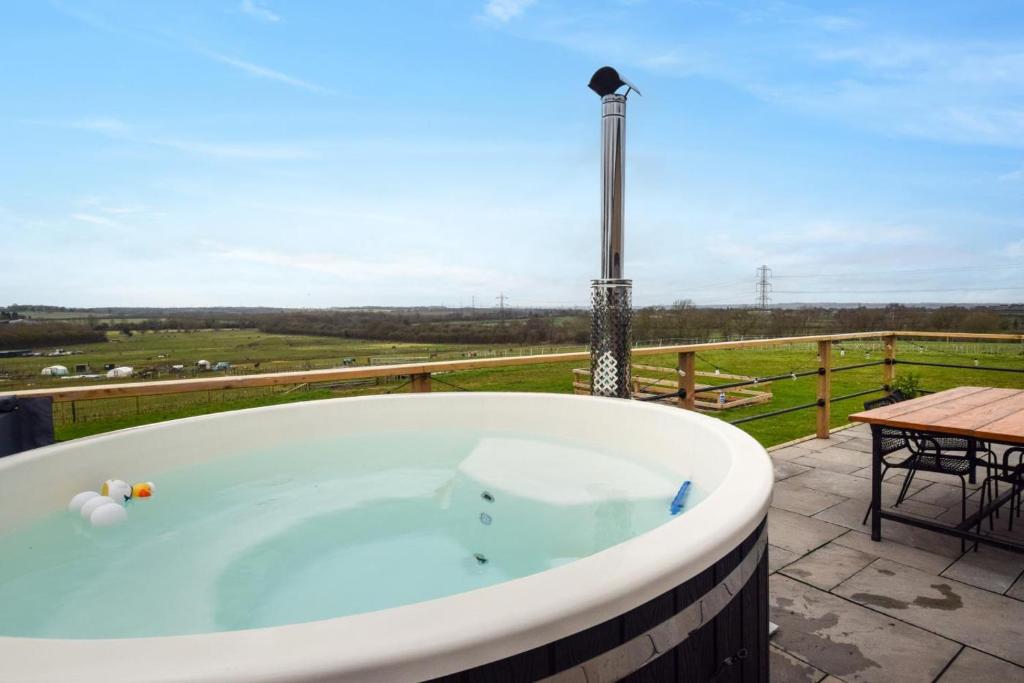 a jacuzzi tub on a patio with a table at 2 Bed in Stanton oc-p30248 in Ticknall