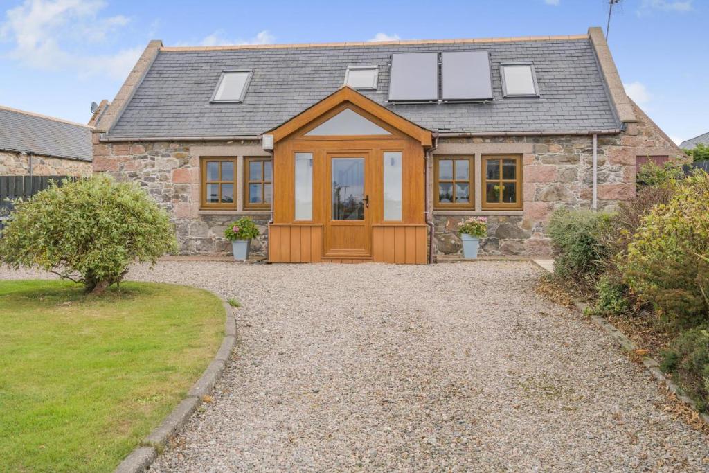 a stone house with a wooden door and windows at 2 Bed in Hatton oc-t32765 in Peterhead