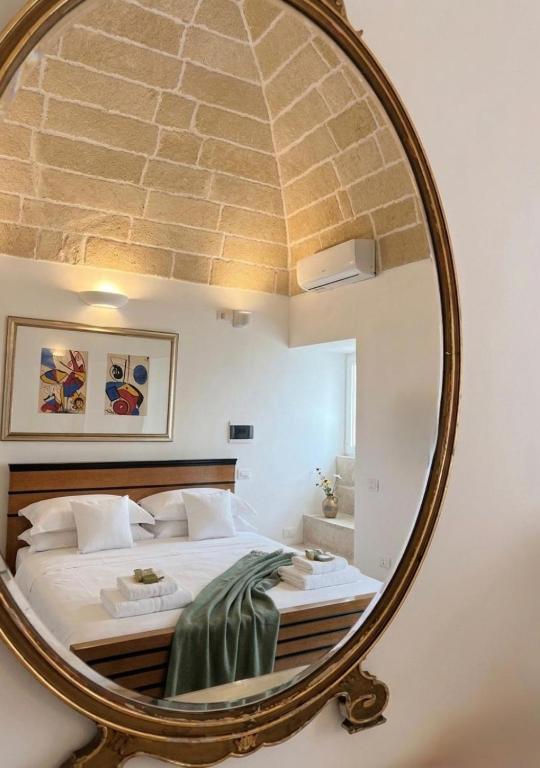 a bedroom with a large mirror on the wall at Gallipoli - Suite Levante in Gallipoli