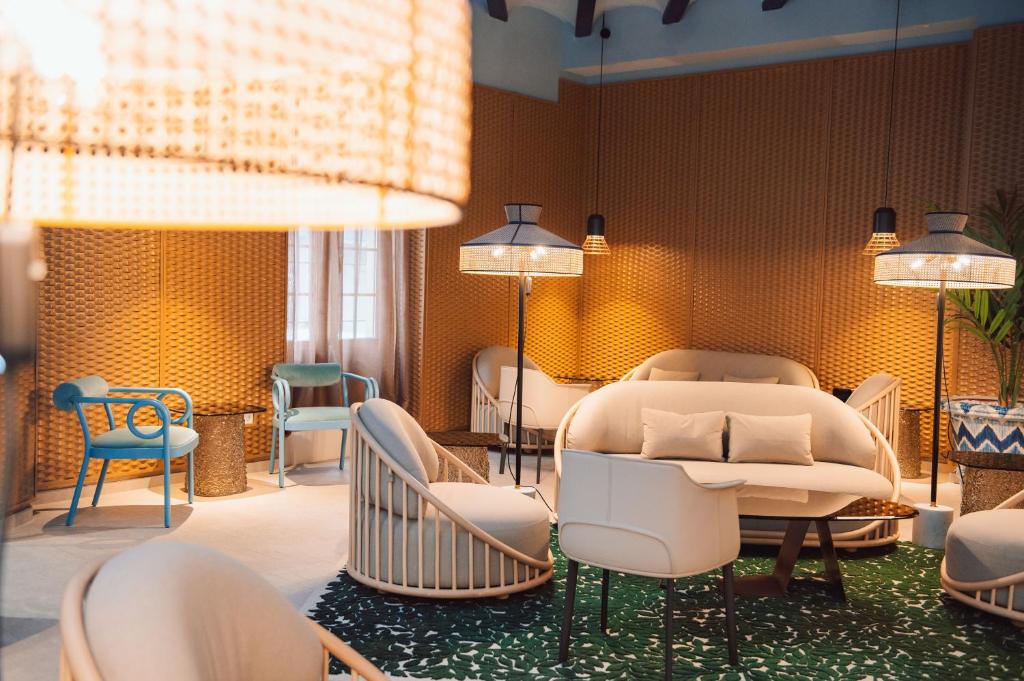 a salon with a waiting room with chairs and a couch at Nomada House by SH Hoteles in Denia