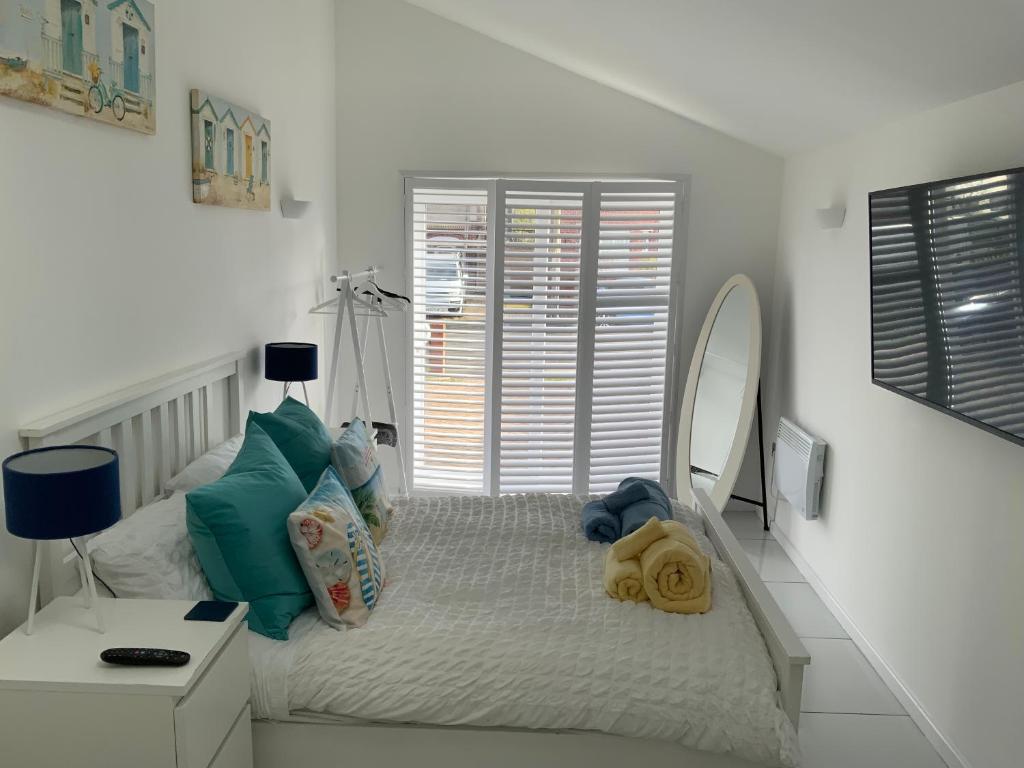 a bedroom with a bed with a large mirror at Double Bedroom with Private Entrance in Weymouth