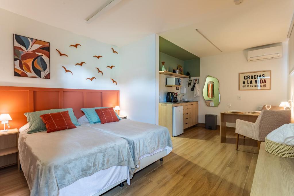a bedroom with a bed with birds on the wall at Studio Andorinhas in Brasília