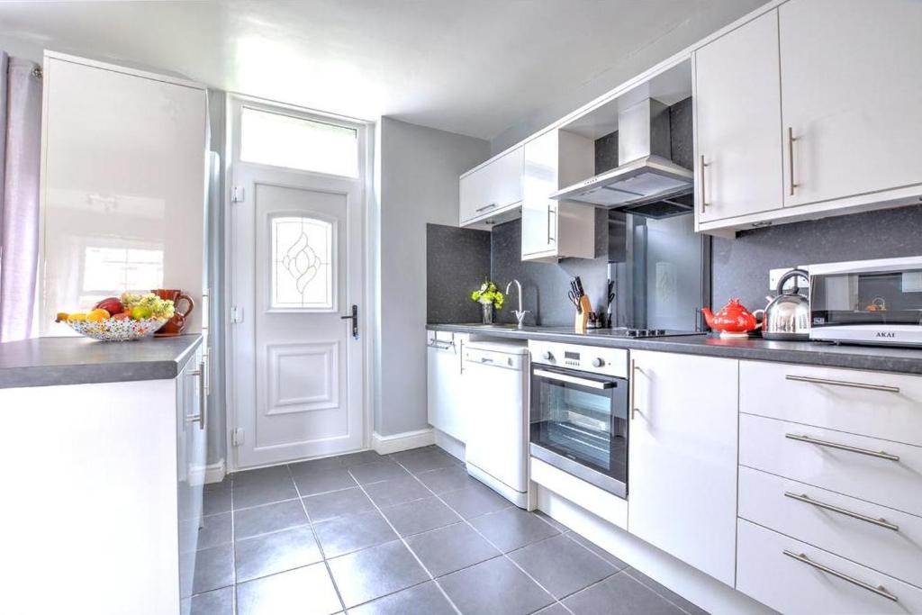 a kitchen with white cabinets and a counter top at 2 Bed in Skipton oc-ds221 in Skipton