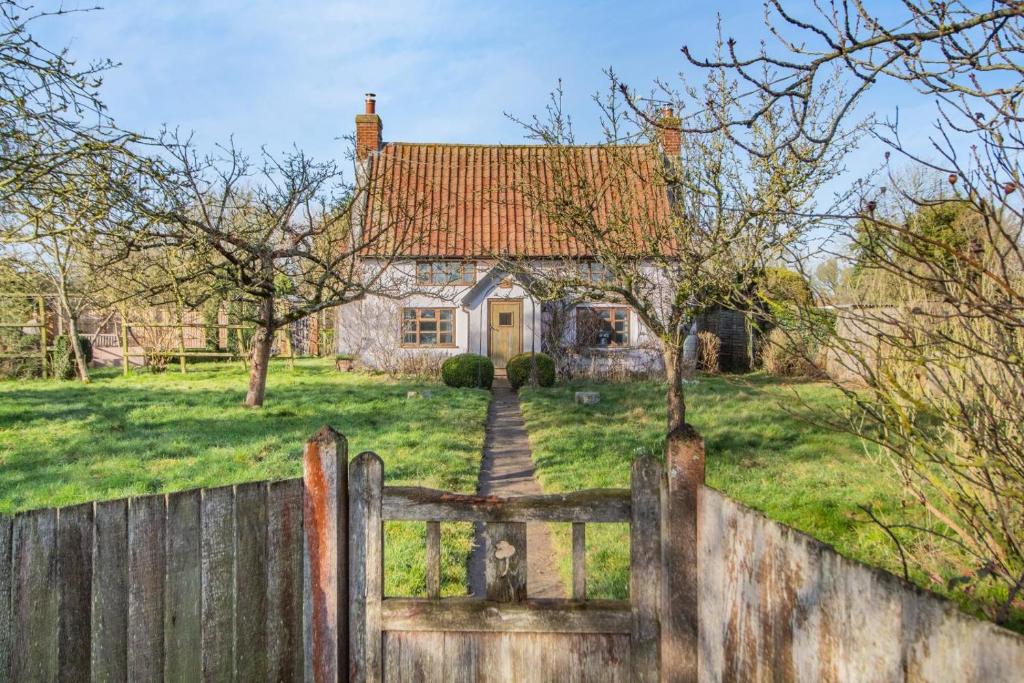 an old house behind a fence with a gate at 2 Bed in Dennington oc-b28093 in Dennington