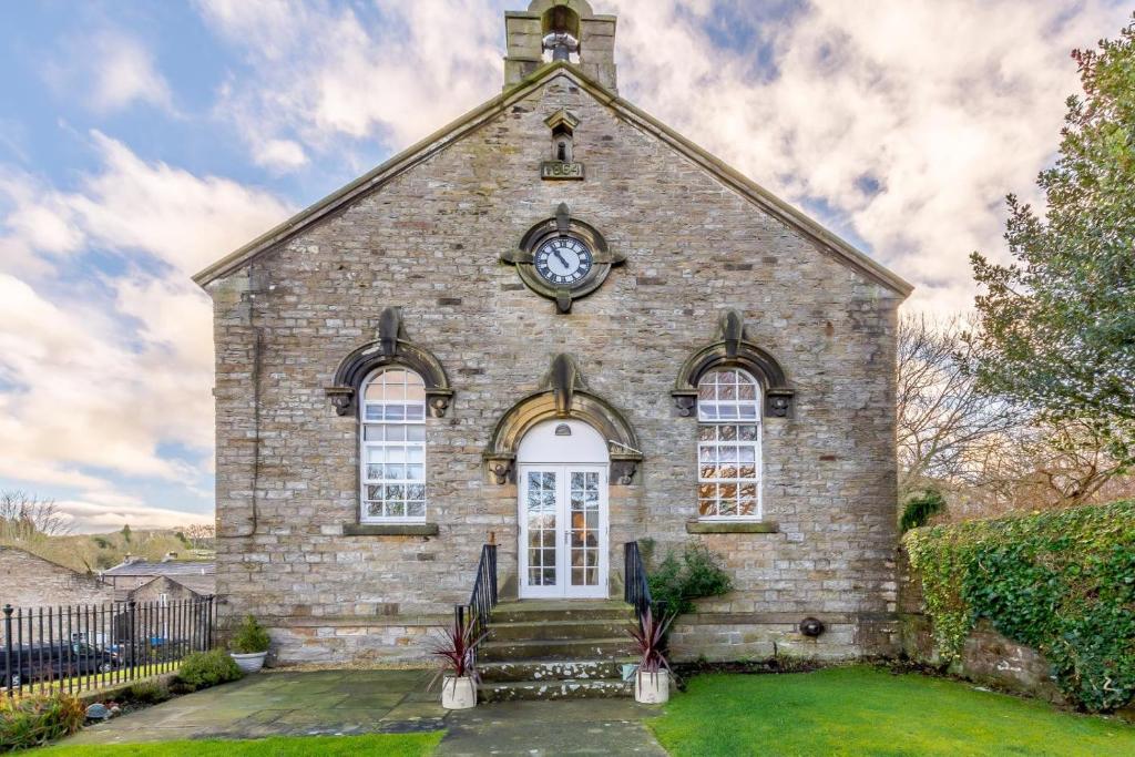 an old brick church with a clock on it at 3 Bed in Bainbridge oc-c28300 in Bainbridge