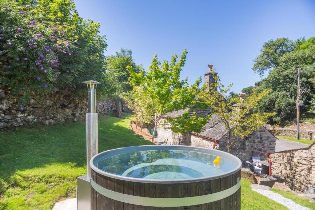 a hot tub in the yard of a house at 2 Bed in Penmaenpool oc-p32333 in Penmaenpool