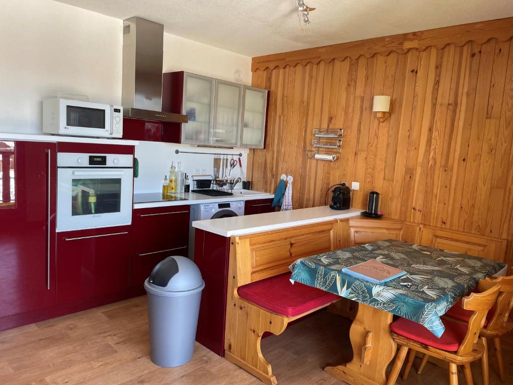 a kitchen with a small table and a counter top at La Marmotte ensoleillée in Montclar