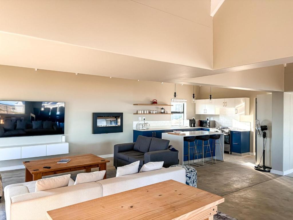 a living room with a couch and a table at Casa Costeira in Britannia Bay
