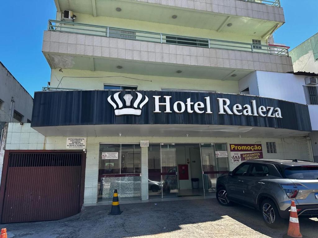 a car parked in front of a hotel relaza at Hotel Realeza in Goiânia