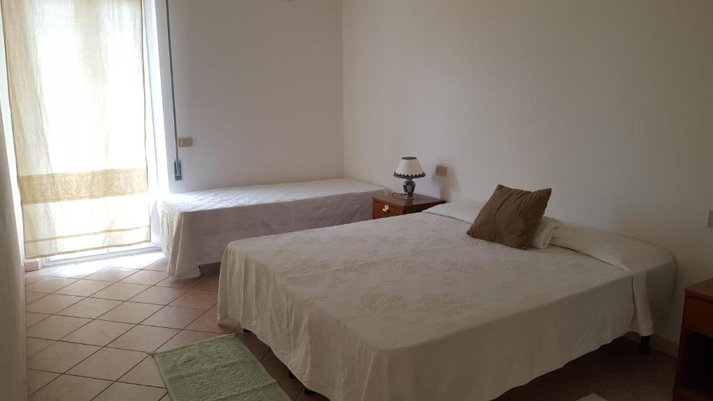 Ένα ή περισσότερα κρεβάτια σε δωμάτιο στο Casa Vacanze Capoterra