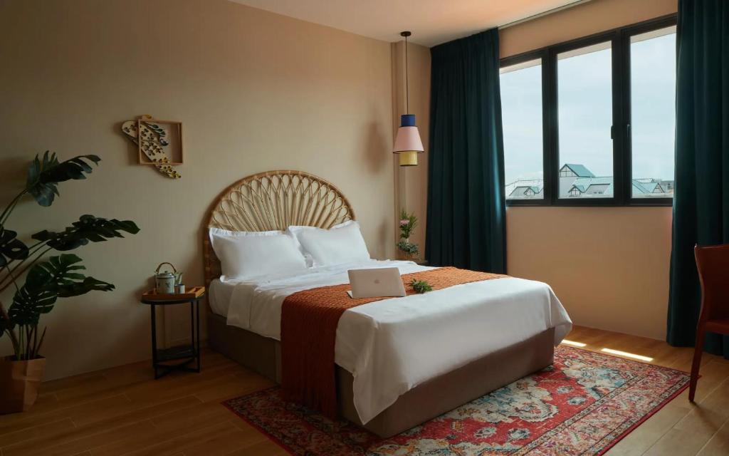 a bedroom with a bed with a laptop on it at House Rong in Singapore