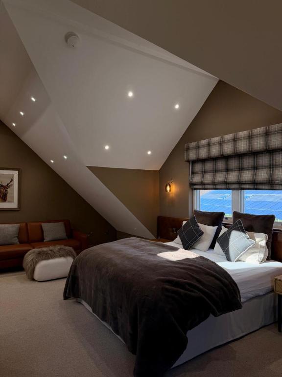 a bedroom with a large bed and a window at The Stables Luxury B&B in Bury