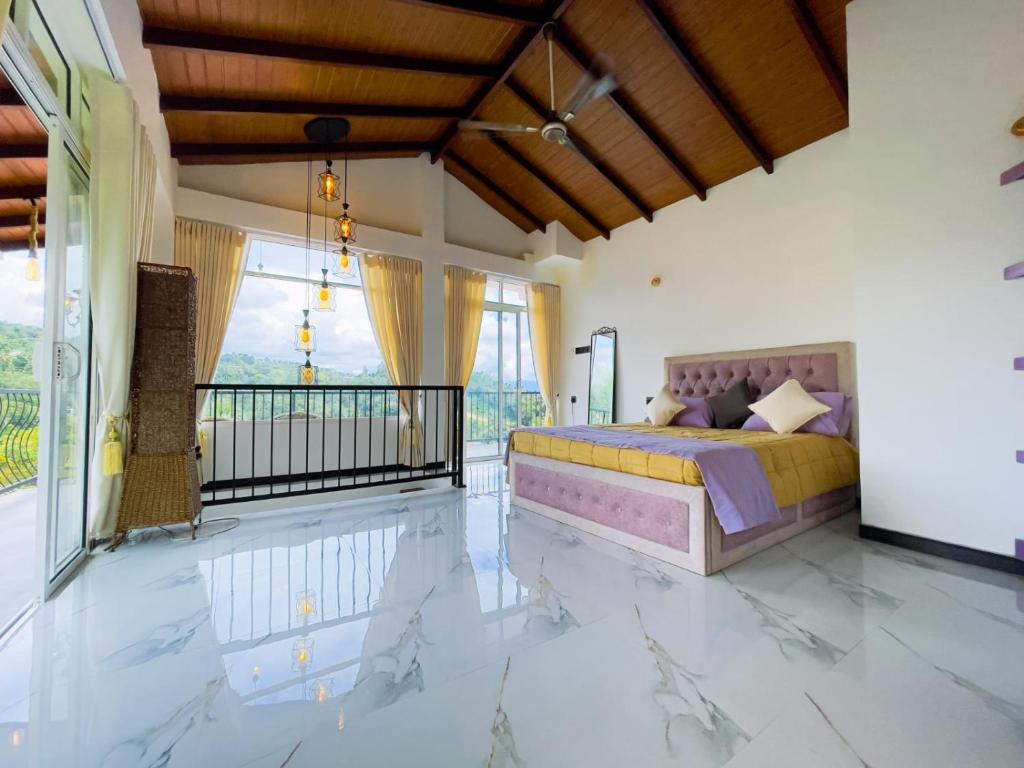 a bedroom with a king sized bed and a balcony at MulBerry Villa in Kandy