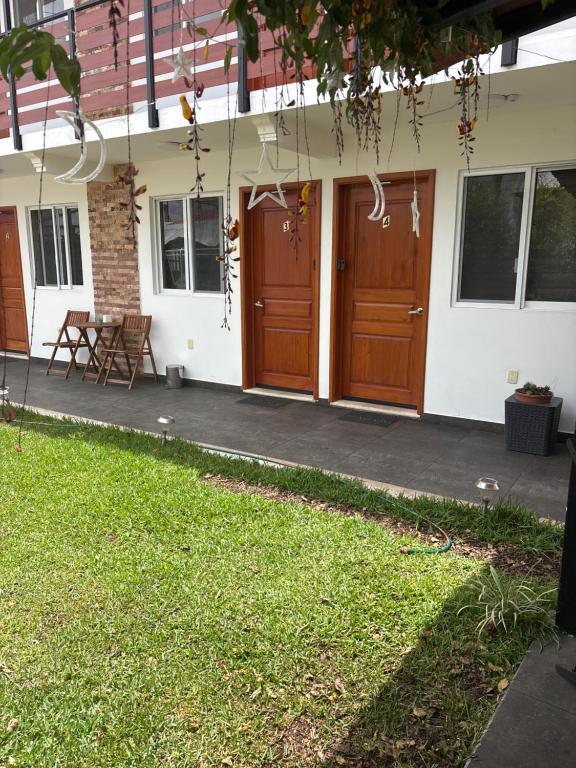 a house with two wooden doors and a patio at KC Suites in Comitán