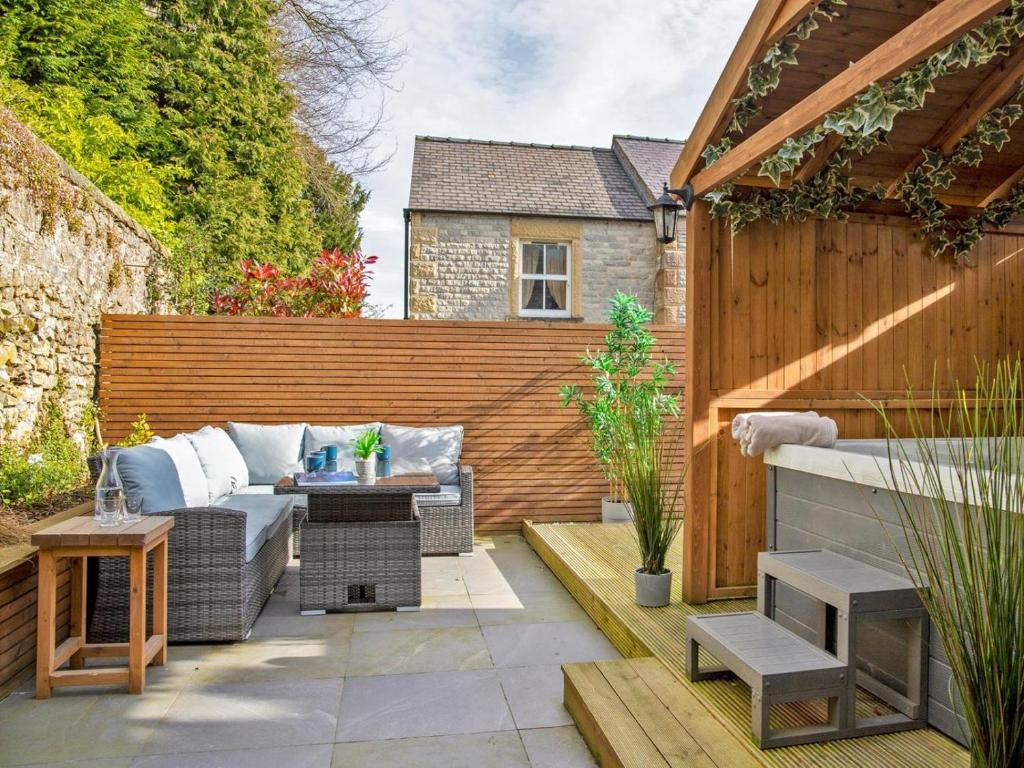 a backyard patio with a couch and a table at 2 Bed in Bakewell oc-90406 in Bakewell