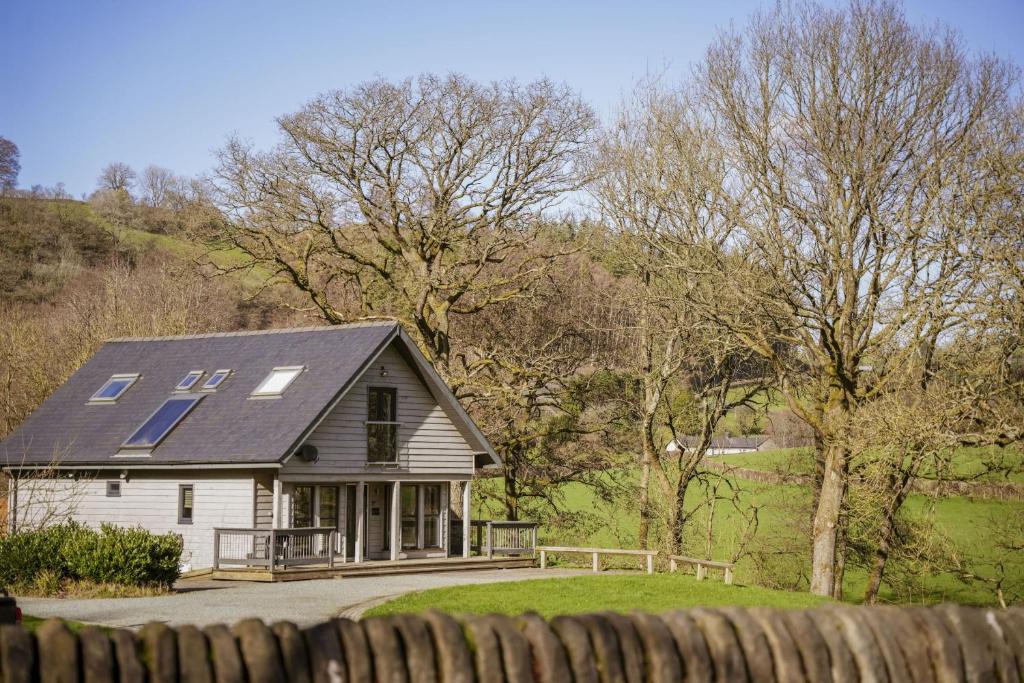 a house with solar panels on top of it at Oak Lodge in Knighton
