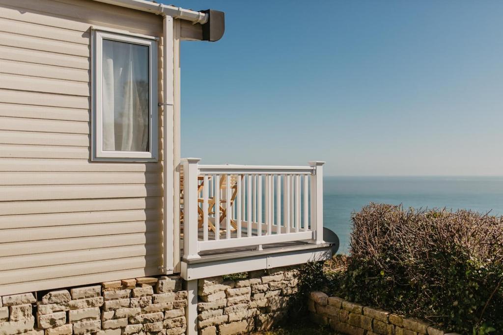 a balcony of a house with the ocean in the background at Upper Cliff 2 in Easton