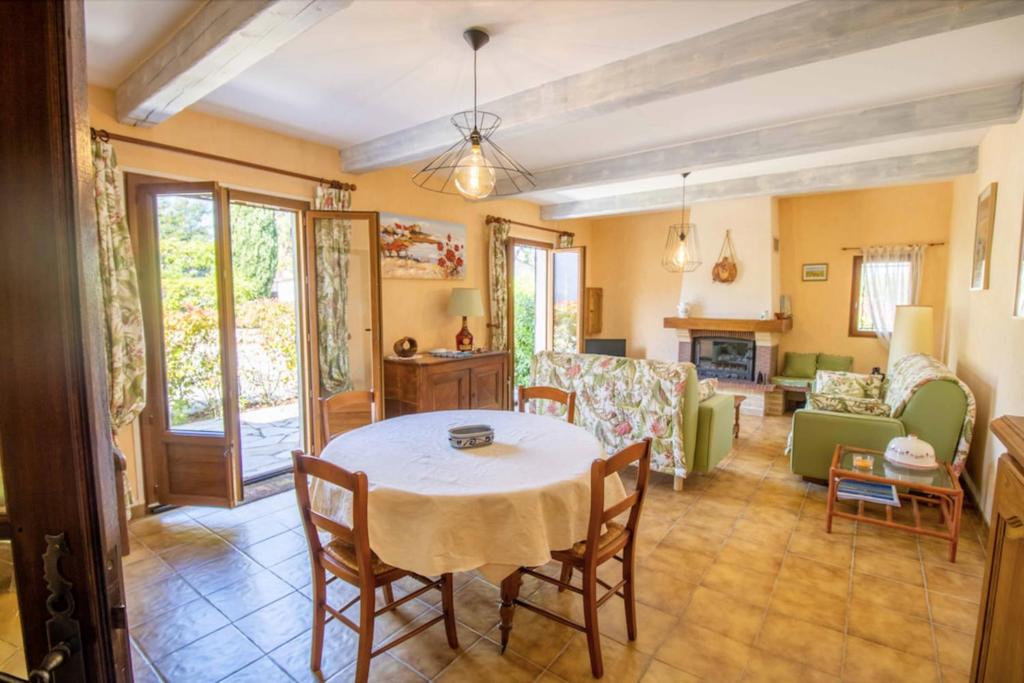 a living room with a table and chairs at Large Spacious House In Fréjus in Fréjus