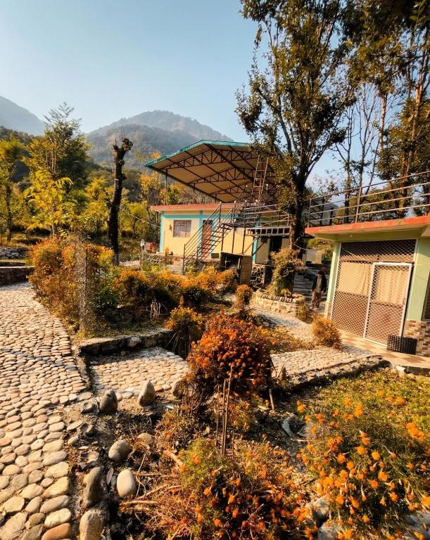 a house with a stone path in front of a house at Peace Forest Retreat in Gopeshwar