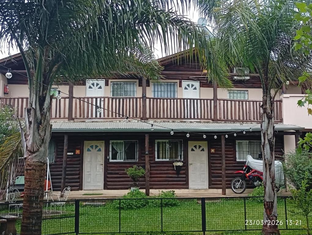 a house with a motorcycle parked in front of it at Cabañas la calma in Concordia