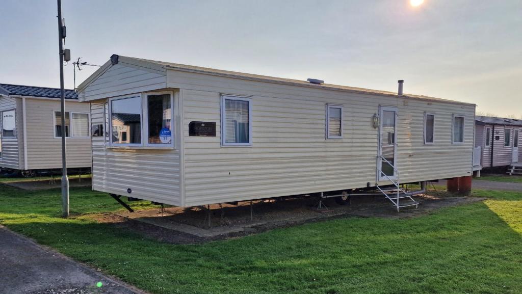 a mobile home is parked in a yard at Bella Family Getaway, Church Farm in Pagham