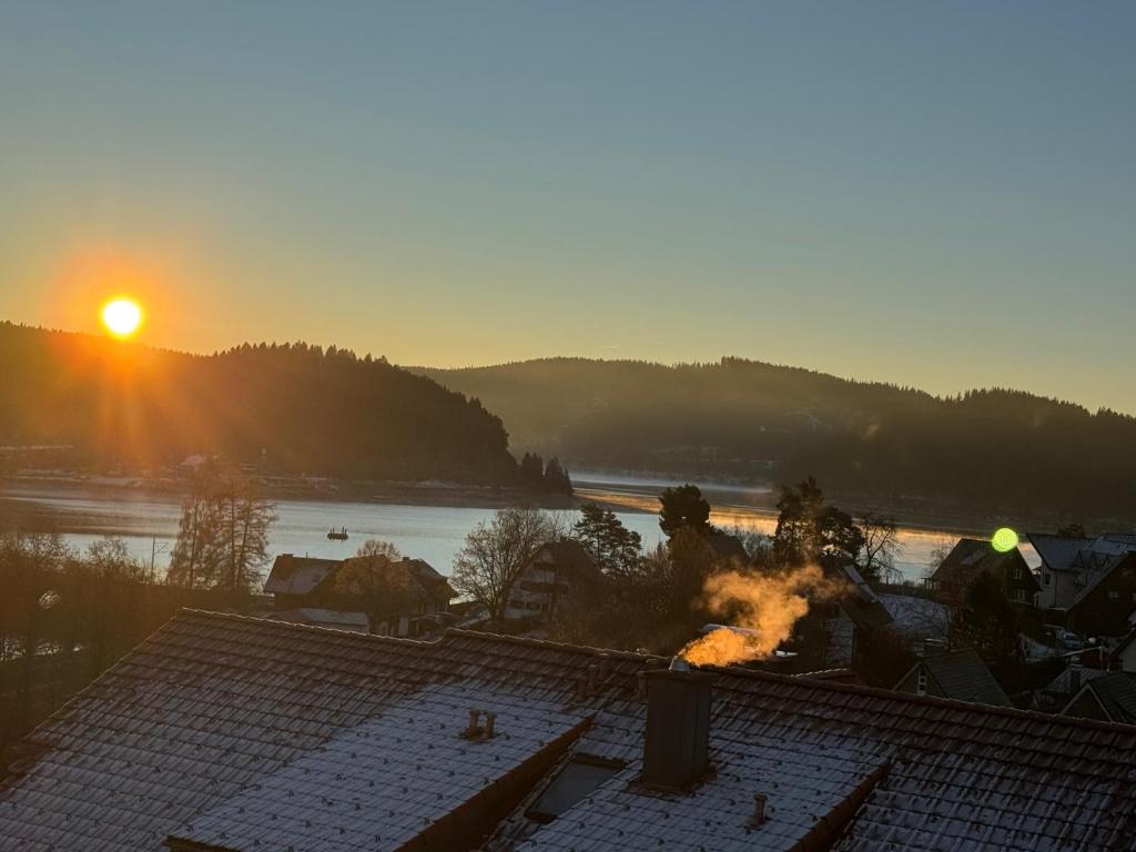 a view of the sunset from the roof of a house at Lakeview Residence in Schluchsee
