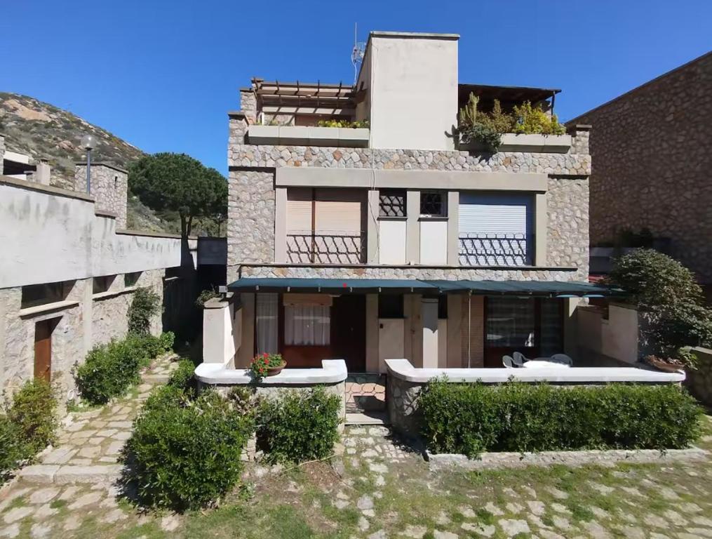a large stone building with plants on it at Giglio Gold in Giglio Porto