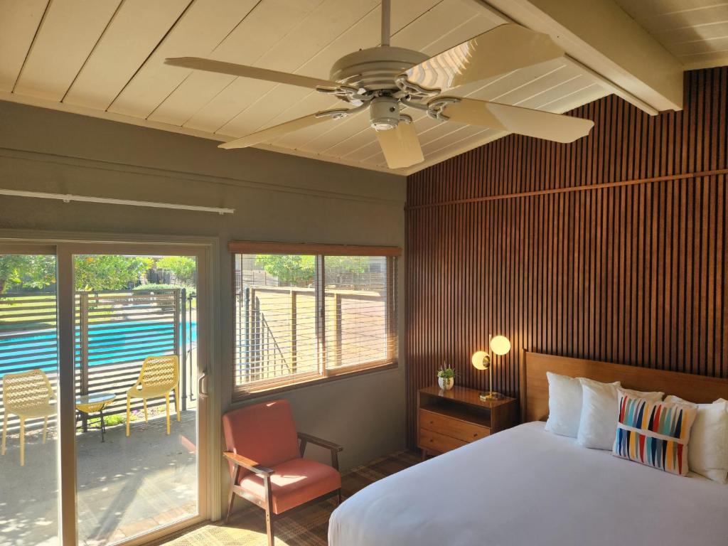 a bedroom with a bed and a ceiling fan at Contenta Inn in Carmel Valley