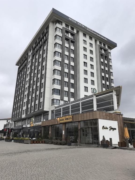 a large white building with a hotel at Nova Vista Deluxe & Suites a Member of Radisson Individuals in Eskisehir