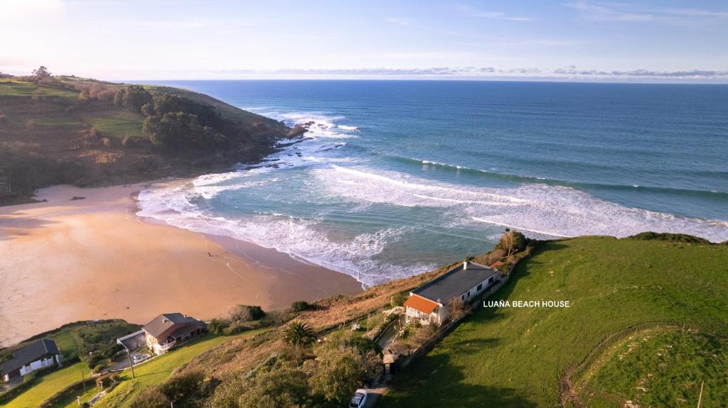 an aerial view of a beach and the ocean at Luaña Beach House in Cóbreces
