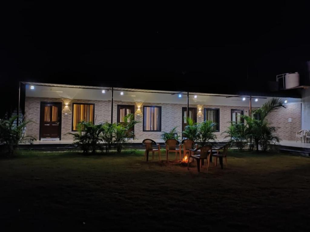 a house at night with a table and chairs at Chandras palace hotel kothar in Kothār