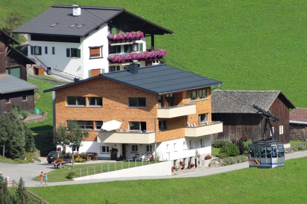 a rendering of a house with a black roof at Appartements Veronika in Silbertal