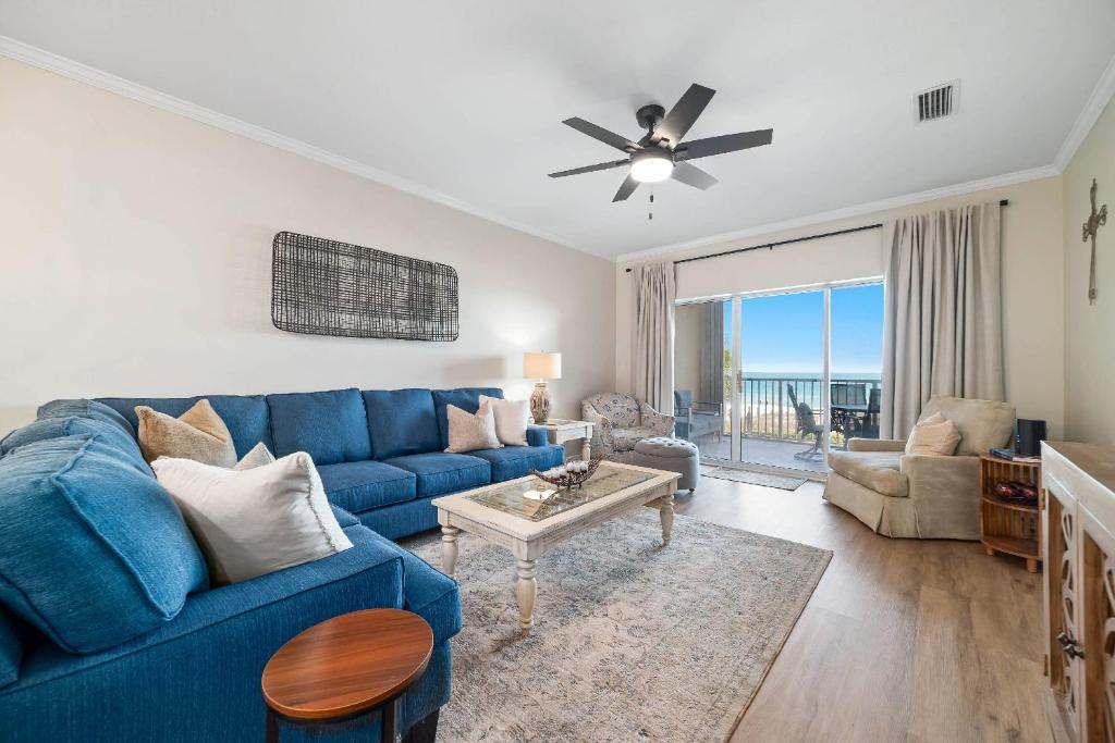 a living room with a blue couch and a table at Marlin Key 1B in Orange Beach