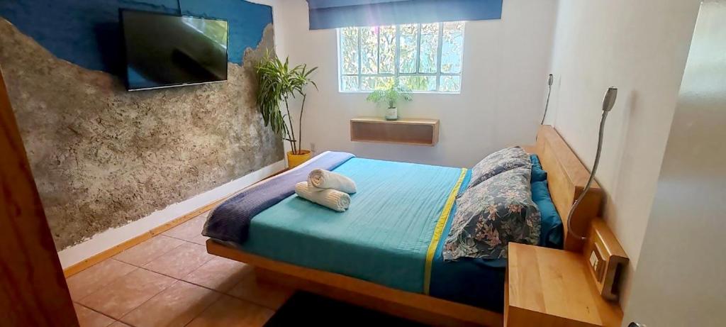a bedroom with a bed with a stuffed animal on it at Punto DF - Airport in Mexico City