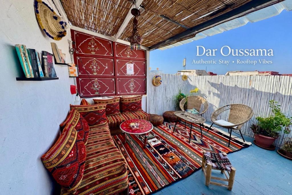a room with a bed and a table and chairs at Dar Oussama in Rabat