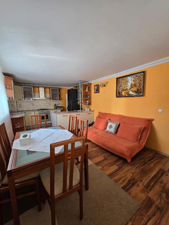 a living room with a couch and a table at Власний будинок in Rakhiv