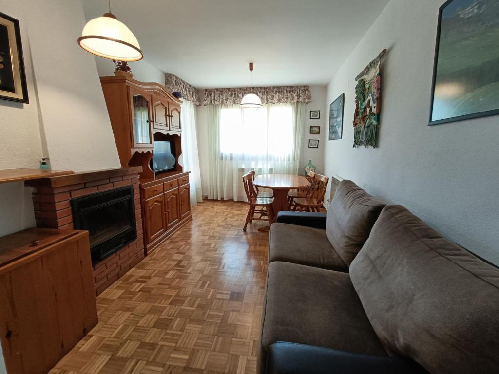 a living room with a couch and a table at Apartamento Maladeta in Torla-Ordesa