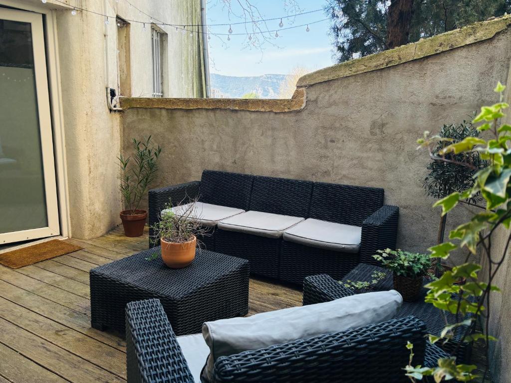 a patio with a couch and chairs and a table at Studio, terrasse & cathédrale in Valence
