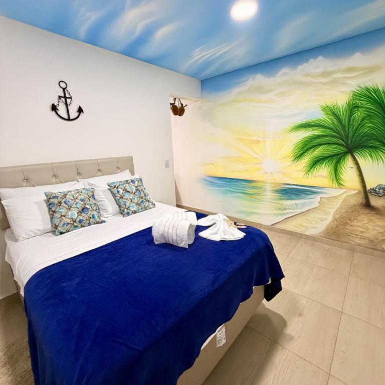 a bedroom with a bed with a painting on the wall at Quarto Tema Praia - Top Country Ranch in Boituva