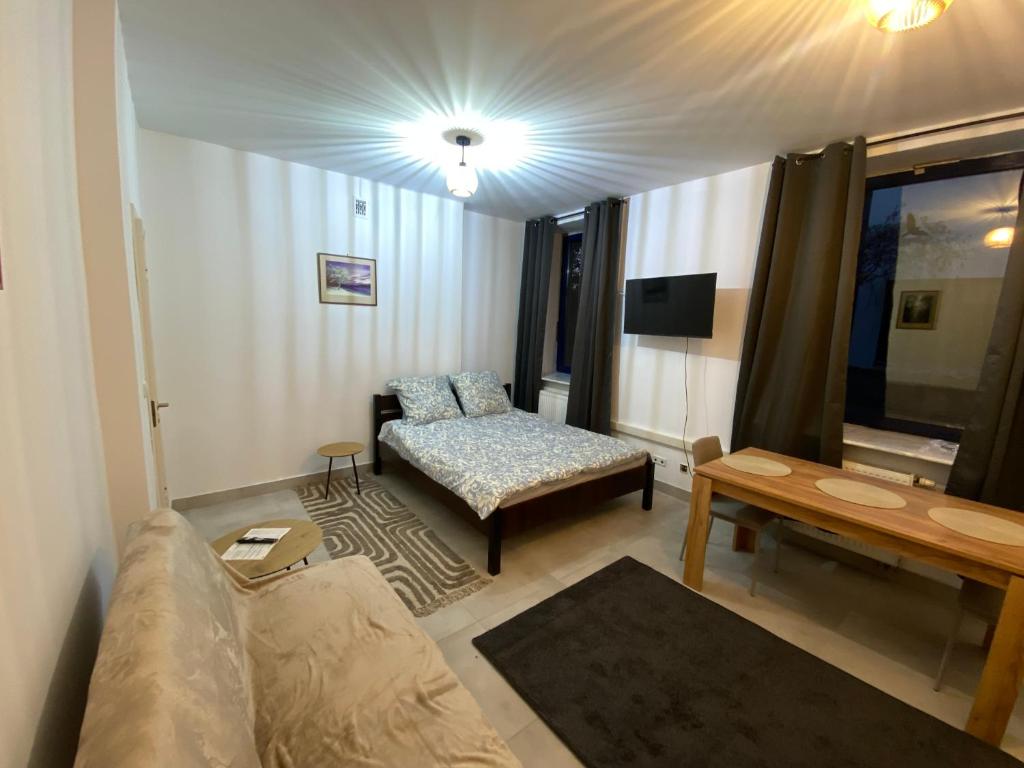 a living room with a couch and a table at Mossmarken Stay in Warsaw