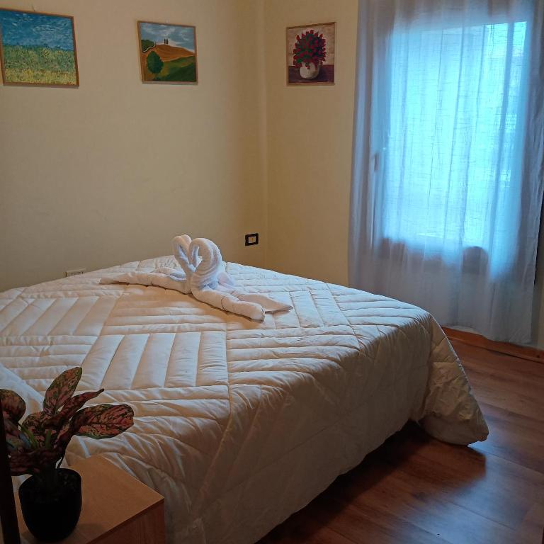 a bedroom with a bed with a towel on it at La Casa del Zuf in Carlino