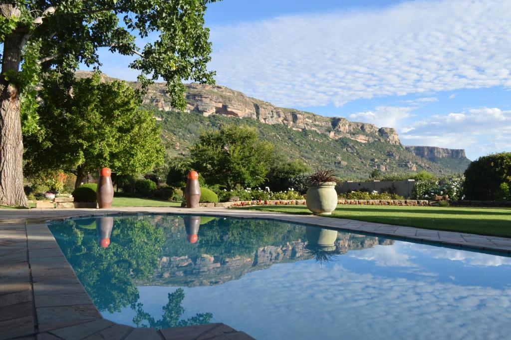 a swimming pool with a mountain in the background at Botleng Guest House in Boqate