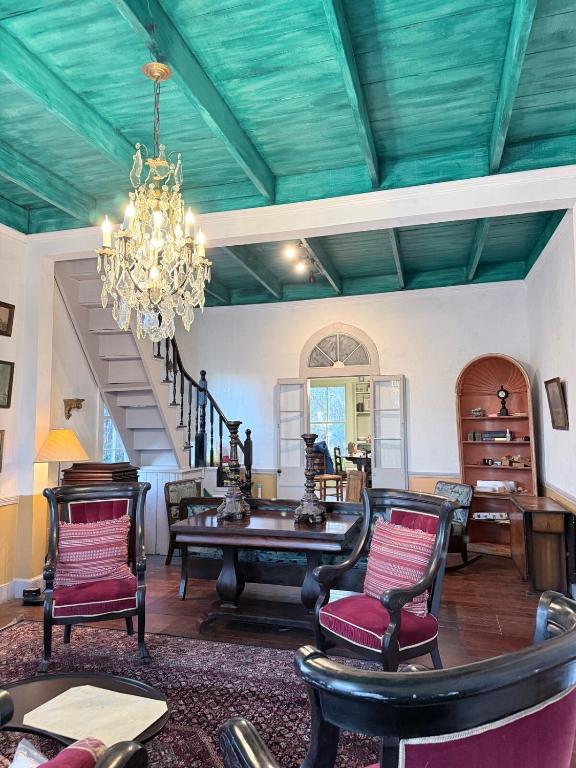 a room with a table and chairs and a chandelier at The Courtableau Cottage in Washington