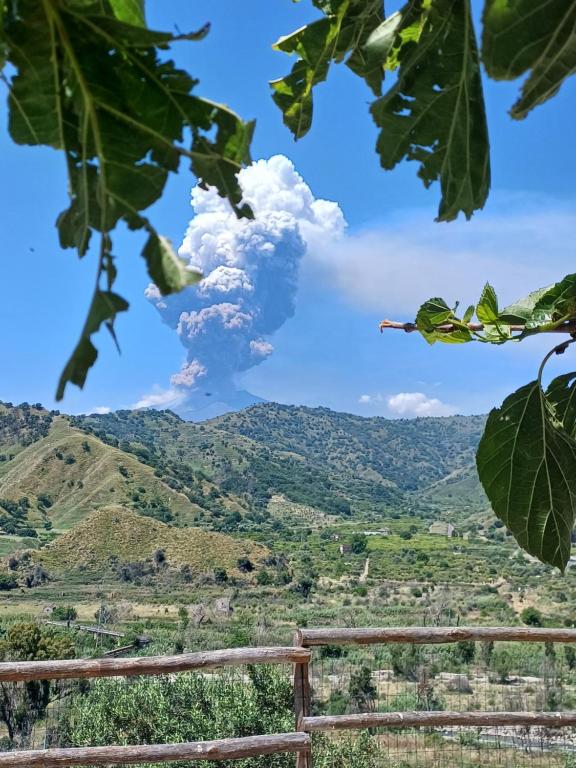 a plume of smoke coming out of a mountain at I TRE CUORI in Taormina