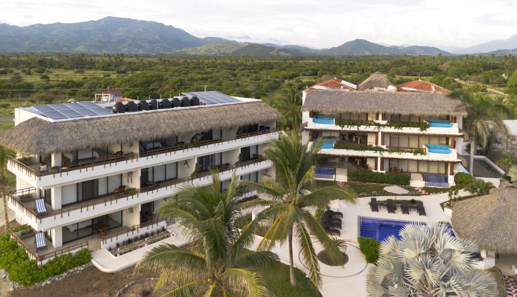 an aerial view of the resort with mountains in the background at El Secreto Residencial in Zihuatanejo