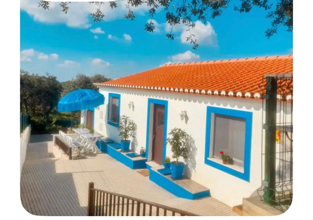 a small white house with an orange roof at Casa do Ti Chico in São Luis