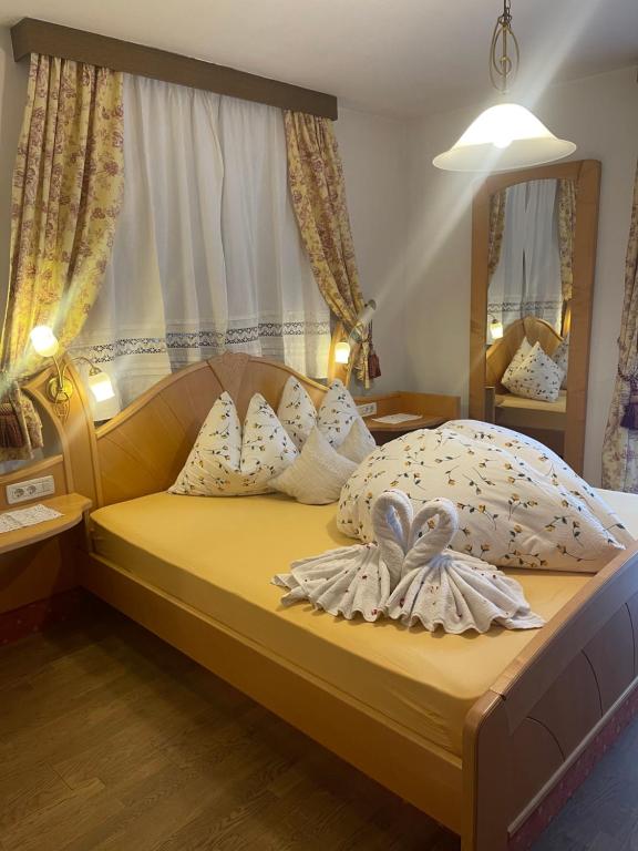 a bedroom with a bed with two towels on it at Haus Käfersberg in Naturno
