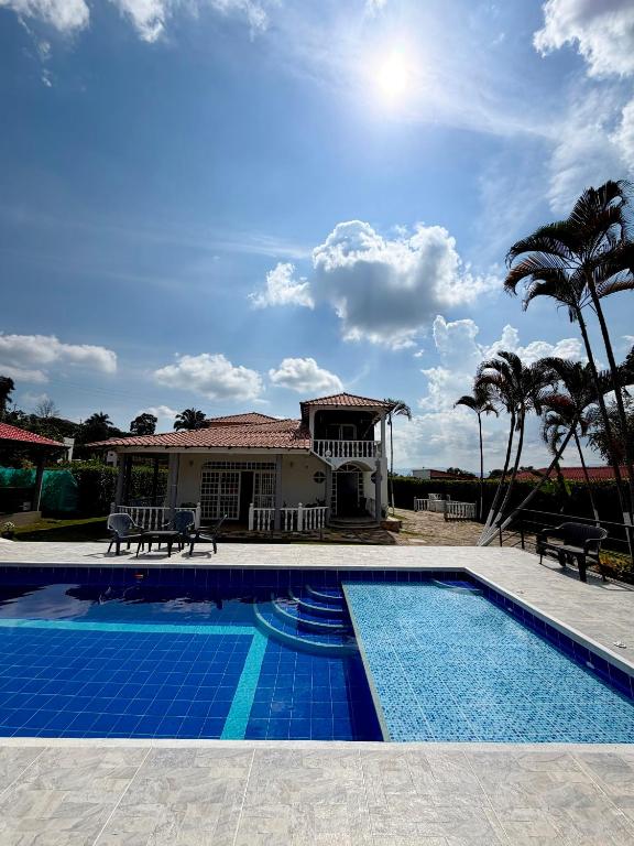 a house with a swimming pool in front of a house at Hotel restaurante hortencia in La Mesa