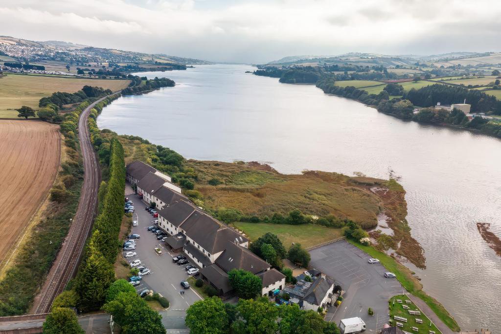 an aerial view of a river with cars parked at Avocet in Newton Abbot